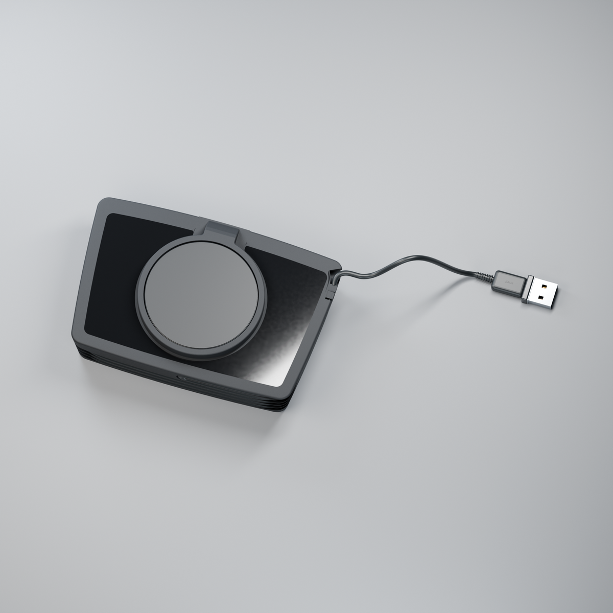 Flatboy from above, showing the horizontal charging puck, black acrylic surround and cable with USB-A plug.