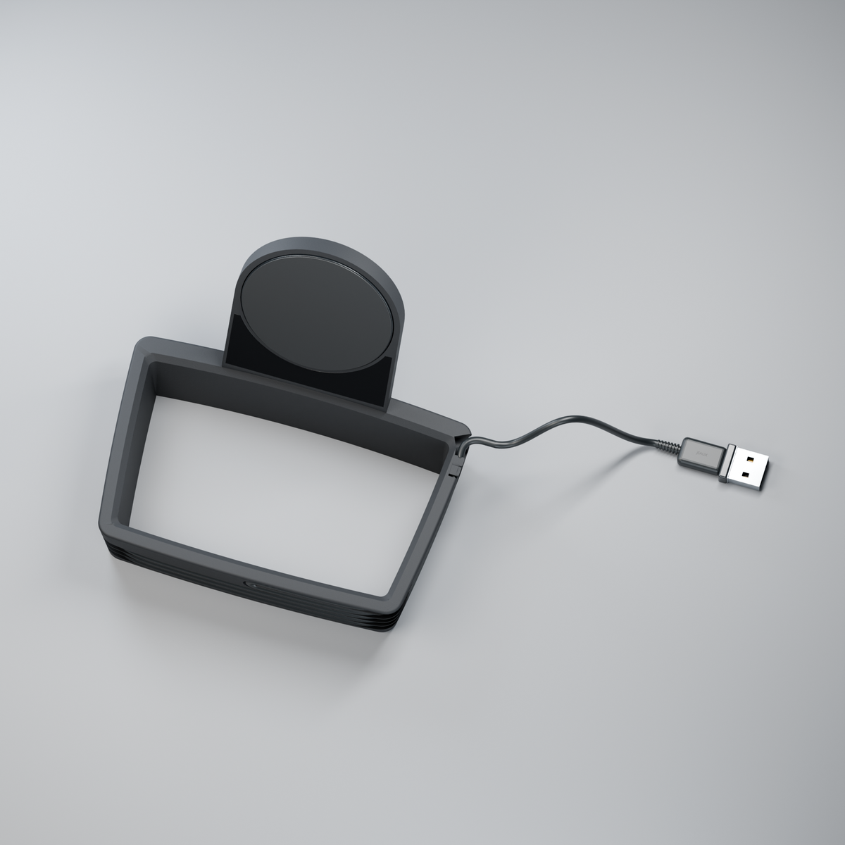 Puck Frame from above, showing the open frame beneath the charging puck and the cable with USB-A plug.